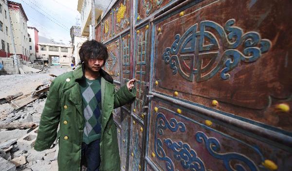 Yang Yang, a 23-year-old young man who saved seven lives from the quake debris, shows the house that witnessed his heroism in Gyegu, northwest China's Qinghai Province, April 17, 2010. On feeling the earthquake on April 14, Yang yang rushed out of his working place and found neighbouring residential buildings crumbled to ruins. With bare hands, Yang digged out seven buried people in all.