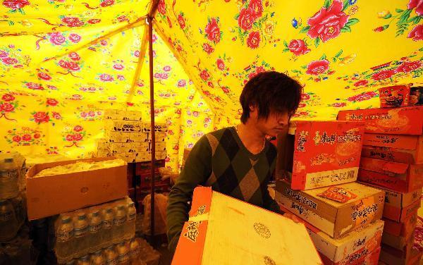 Yang Yang, a 23-year-old young man who saved seven lives from the quake debris, shows the house that witnessed his heroism in Gyegu, northwest China's Qinghai Province, April 17, 2010. On feeling the earthquake on April 14, Yang yang rushed out of his working place and found neighbouring residential buildings crumbled to ruins. With bare hands, Yang digged out seven buried people in all.