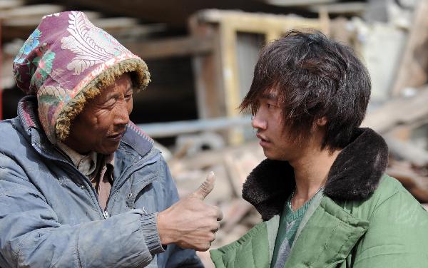 Yang Yang, a 23-year-old young man who saved seven lives from the quake debris, shows the house that witnessed his heroism in Gyegu, northwest China's Qinghai Province, April 17, 2010. On feeling the earthquake on April 14, Yang yang rushed out of his working place and found neighbouring residential buildings crumbled to ruins. With bare hands, Yang digged out seven buried people in all.