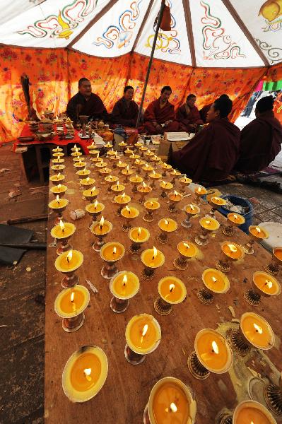 Monks chant prayers for the victims in a tent in quake-hit Gyegu Town of Yushu County, northwest China's Qinghai Province, April 17, 2010.