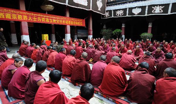 Tibetan Buddhist monks pray at Lhasa's ancient Jokhang Temple in southwest China's Tibet Autonomous Region, April 17, 2010. Monks on Saturday prayed at Jokhang Temple for blessings for quake-affected people of Qinghai Province and donated for the victims. 