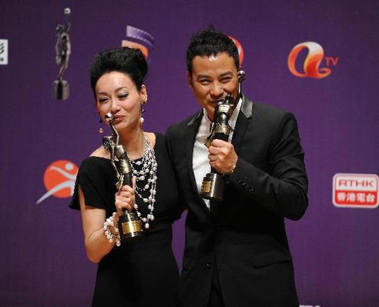 Hong Kong actors Wai Ying-hung and Simon Yam pose for pictures at the backstage after winning the Best Actress and Best Actor awards at the 29th Hong Kong Film Awards April 18, 2010. 