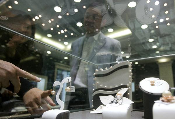 Visitors view pearl studs at the 7th China International Pearl Festival kicked off in Huadong International Jewelry City, a jewelry shopping center, in Shanxiahu Township in Zhuji City, east China's Zhejiang Province, April 18, 2010. (Xinhua)