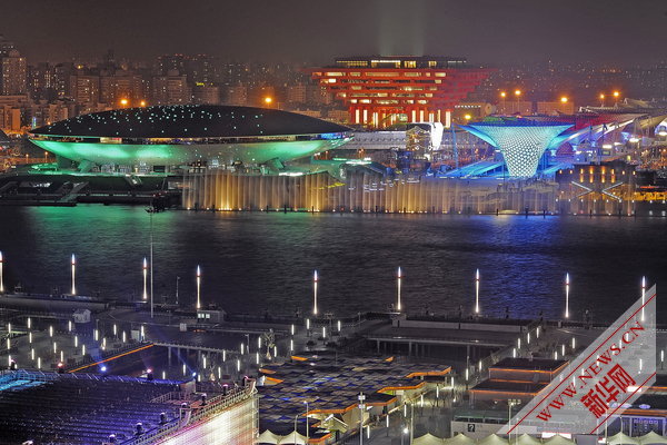 Photo taken on April 17, 2010 shows a group of permanent pavilions irradiated by the nearby music water curtain in a trial operation at the Shanghai EXPO park in Shanghai, China. [Xinhua]