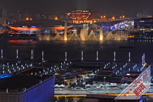 Photo taken on April 17, 2010 shows a group of permanent pavilions irradiated by the nearby music water curtain in a trial operation at the Shanghai EXPO park in Shanghai, China. [Xinhua]