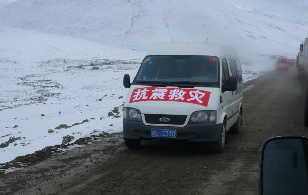 Running on the snow-covered plateau, a long motorcade of cargo vehicles transport quake-relief materials to Yushu, northwest China's Qinghai Province, April 19, 2010. The quake-relief materials were continuously transported to the disaster areas despite the snowfall and frozen road surface. 