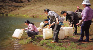 Villagers in Dahuangdi have to climb for two hours to get drinking water from a nearby mountain reservoir.