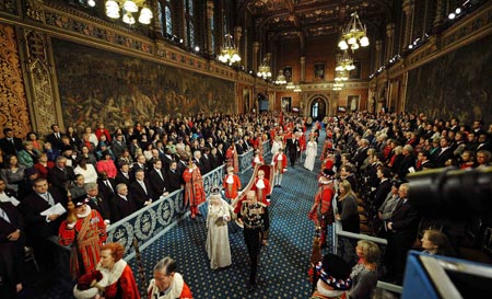 Britain&apos;s Queen Elizabeth walks with her husband Prince Philip through the Royal Gallery before delivering her speech during the State Opening of Parliament at the Houses of Parliament in London November 18, 2009.(Xinhua/Reuters Photo)