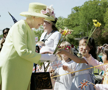 Britain&apos;s Queen Elizabeth II accepts flowers from children while walking during a visit to the Goddard Space Flight Center in Greenbelt, Maryland May 8, 2007. 