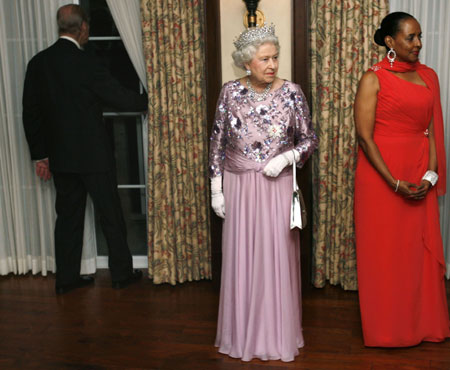 Britain&apos;s Queen Elizabeth (C) and Wanda Henton Brown, the wife of Bermuda Premier Ewart Brown, wait for the beginning of the receiving line as Prince Phillip (L) looks out of a window prior to a state dinner in Bermuda November 25, 2009. The Queen&apos;s three-day visit is in conjunction with the 400th anniversary of settlement on the island. 