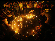 People across China light candles to mourn the Yushu earthquake dead and pray for the affected. [Xinhua]