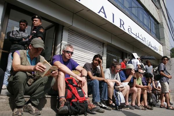 Passengers queue for tickets outside an airline agency in Kathmandu, capital of Nepal, April 22, 2010. Hundreds of foreign passengers stranded in Kathmandu are hopeful of flying home after European governments temporary reopened the airports. The closure of the European airspace casued by the Icelandic volcanic ash has trapped hundreds of thousands of passengers around the world, crippling airlines. [Bimal Gautam/Xinhua]