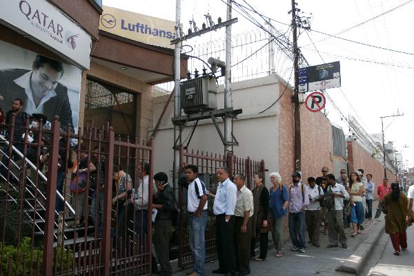 Passengers queue for tickets outside an airline agency in Kathmandu, capital of Nepal, April 22, 2010. Hundreds of foreign passengers stranded in Kathmandu are hopeful of flying home after European governments temporary reopened the airports. The closure of the European airspace casued by the Icelandic volcanic ash has trapped hundreds of thousands of passengers around the world, crippling airlines. [Bimal Gautam/Xinhua]