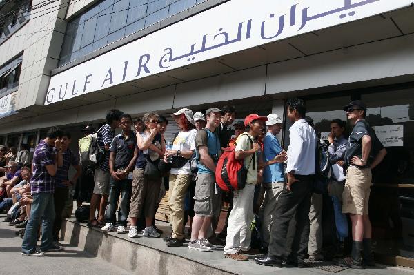 Passengers queue for tickets outside an airline agency in Kathmandu, capital of Nepal, April 22, 2010. Hundreds of foreign passengers stranded in Kathmandu are hopeful of flying home after European governments temporary reopened the airports. The closure of the European airspace casued by the Icelandic volcanic ash has trapped hundreds of thousands of passengers around the world, crippling airlines. [Bimal Gautam/Xinhua]