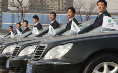Dazhong Car Rental employees stand beside their fleet of business sedans, with brands ranging from BMW to Mercedes, on December 30, 2009. These luxury vehicles will be sent to high-end hotels during the Expo. Photo: IC 