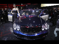 A model stands next to the new generation Maybach car during its world premiere ceremony ahead of the Beijing Auto Show, in Beijing April 22, 2010. [China Daily via Agencies]