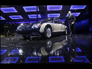 A staff member walks out of the new generation Maybach car during its world premiere ceremony ahead of the Beijing Auto Show, in Beijing April 22, 2010. [China Daily via Agencies]