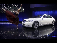 A ballet dancer performs next to a new Mercedes-Benz S400 Hybrid car at the 'Mercedes-Benz Car Luxury and Leadership Evening' ahead of the Beijing Auto Show, in Beijing April 22, 2010.[China Daily via Agencies]