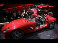 A visitor sits in the new Mercedes-Benz SLS AMG at the 'Mercedes-Benz Car Luxury and Leadership Evening' ahead of the Beijing Auto Show, in Beijing April 22, 2010. Automakers from around the world are showing off their latest products and technology at the Beijing Auto Show, which opens this week. [China Daily via Agencies]