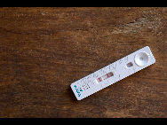 Fifteen minutes later, the result is in. The two red lines indicate that Kadijatou has malaria. Kanda's test is also positive. But because the children were able to access treatment immediately, their chances of a quick recovery are good. [MSF/Barbara Sigge] 