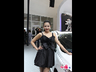 A model poses next to a car during 2010 Beijing International Automotive Exhibition (also known as Auto China 2010) which open to the public from April 23 to May 2 in Beijing, China. [Wang Ke, Wu Huanshu/China.org.cn]