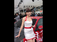 A model poses next to a car during 2010 Beijing International Automotive Exhibition (also known as Auto China 2010) which open to the public from April 23 to May 2 in Beijing, China. [Wang Ke, Wu Huanshu/China.org.cn]