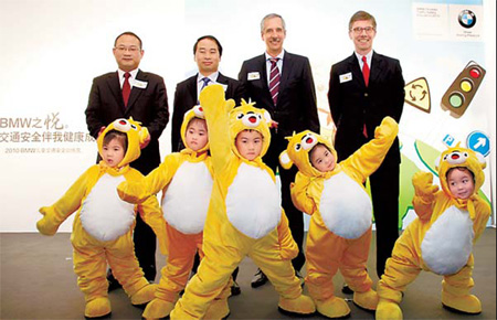 BMW executives and senior government officials with children at the unveiling ceremony. 