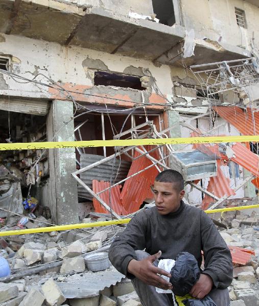 A man sits in front of his shop which was destroyed in a car bomb attack near Haifa Street, central Baghdad April 23, 2010. The toll from several bomb blasts that struck Shiite areas of the Iraqi capital on Friday reached 52 killed and 106 wounded, an Interior Ministry source said. [Xinhua/Reuters Photo] 