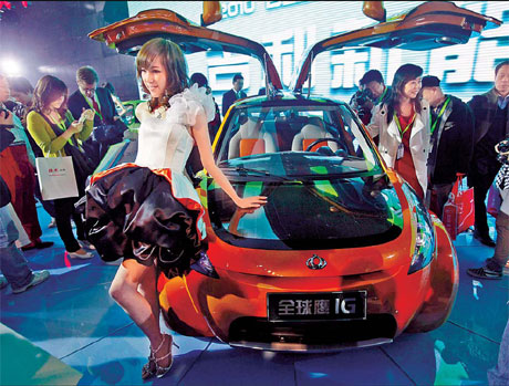 A model poses near a new Intelligent Geely hybrid car at the Beijing Auto Show in Beijing on Friday. China overtook the United States as the world's biggest auto market in terms of number of vehicles sold in 2009, helped by government incentives. Story on page 13. [Photo by Jason Lee/Reuters]