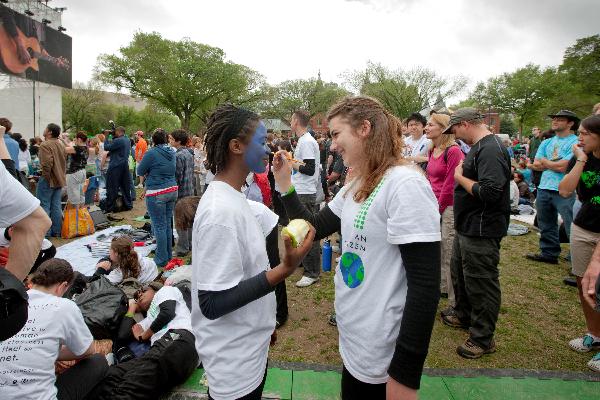 A woman helps her friend make up as the Na&apos;vi in the movie Avator at a concert named Climate Rally at the National Mall in Washington D.C, capital of the United States, April 25, 2010. [Zhu Wei/Xinhua]