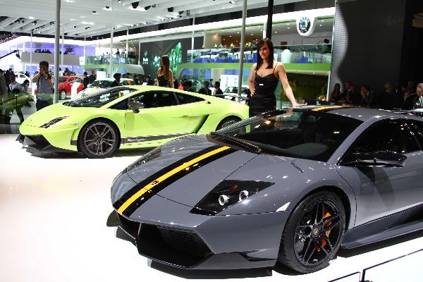 A model poses beside a new Lamborghini car during the media preview at the Beiijng Auto Show on April 23, 2010. In total, nearly 2100 companies from 16 coutries and regions will exhibit during 2010 Beijing International Automotive Exhibition (Auto China 2010) . [Xinhua]