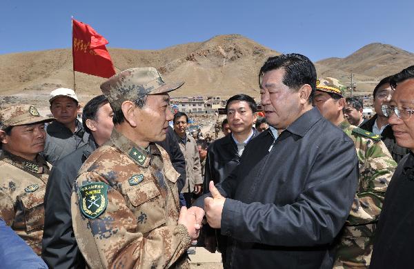 Jia Qinglin (2nd R), chairman of the National Committee of the Chinese People's Political Consultative Conference shakes hands with a Chinese military officer in quake-hit Yushu County, northwest China's Qinghai Province, on April 26, 2010. (Xinhua