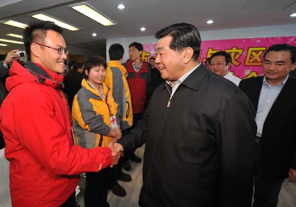 Jia Qinglin (R), chairman of the National Committee of the Chinese People's Political Consultative Conference, shakes hands with a member of Taiwan Medical and Rescuring team for Yushu earthquakes in Xining, capital of China's Qinghai Province, on April 26, 2010. 
