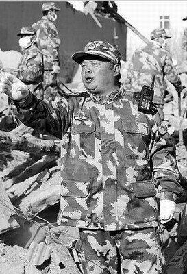 Shi Huajie, chief of the armed police force unit in Yushu, guides rescue work in Gyegu town of Yushu prefecture days after the earthquake. 