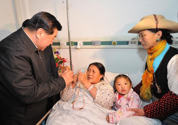 Jia Qinglin (L), chairman of the National Committee of the Chinese People's Political Consultative Conference, visits the injured people from Yushu earthquakes in Xining, capital of northwest China's Qinghai Province, on April 26, 2010. 