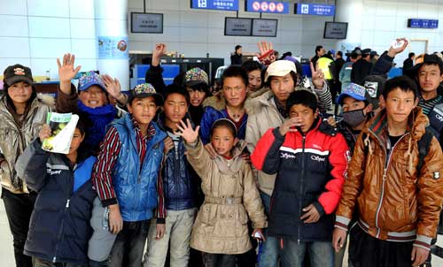 Children from the Yushu welfare house pose for photos before boarding the plane to Xining at the Yushu airport, northwest China's Qinghai province, April 26, 2010. 