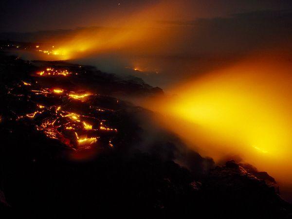 Lava Near Kilauea The Pacific smolders as lava from Hawaii’s Kilauea Volcano hits the ocean. Kilauea is a shield volcano, or a low, gently sloping volcano built almost entirely from basaltic lava flows. It is one of five such volcanoes that make up Hawaii’s Big Island.[Chris Johns/CNTV]