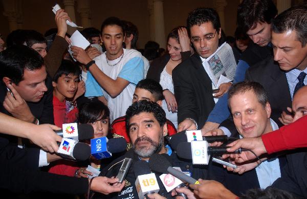 Argentina national team coach Diego Maradona (front C) is interviewed while promoting 2010 South Africa World Cup themed books at the Buenos Aires International Book Fair 2010 in Buenos Aires, Argentina, on April 26, 2010. (Xinhua/Roberto Azcarate)