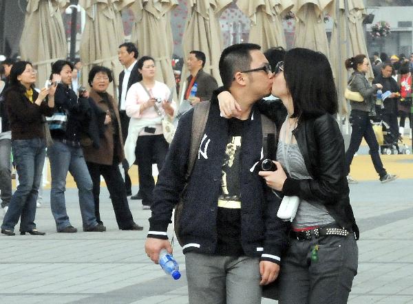 Young lovers kiss during the trial operation in Shanghai Expo Park in Shanghai, east China, April 23, 2010. The Shanghai expo conducted trial operations for six times on April 20 - 26. [Xinhua/Wang Song]