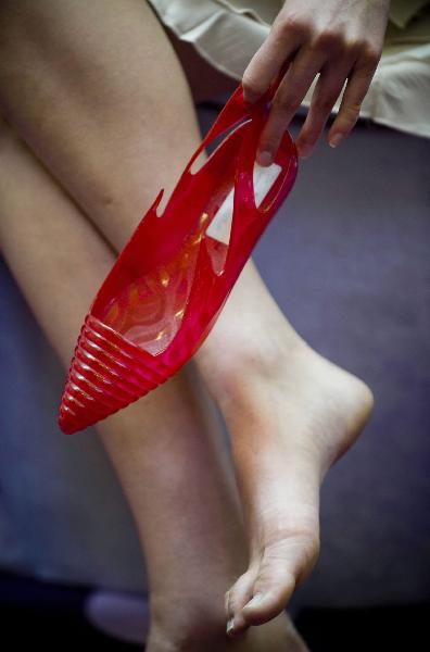 Photo taken on April 27, 2010, shows a model displaying a pair of plastic shoes made in 1984. An antique shoes show was held in Hong Kong, on April 27, 2010. 