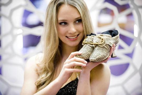 Photo taken on April 27, 2010, shows a model displaying a pair of shoes made in 1750. An antique shoes show was held in Hong Kong, on April 27, 2010.