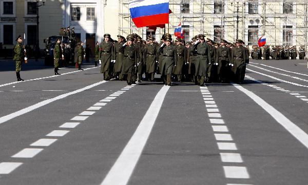 Armed services members march during a rehearsal of a parade marking the 65th anniversary of the victory in the Great Patriotic War, as the then Soviet Union and now Russia have called that phase of World War II. [Lu Jinbo/Xinhua]