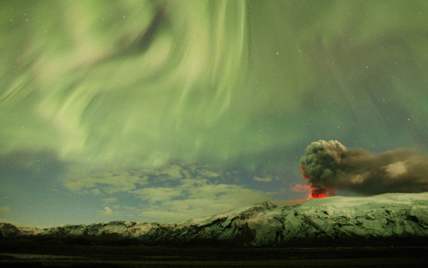 The Northern Lights appear above the ash plume of Iceland&apos;s Eyjafjallajokull volcano in the evening April 22, 2010. 