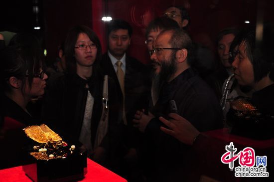 Wallace Chan explains to the visitors the idea and technique he applied in creating the Epiphany of Dragon Cicada, which he donates to the museum. [Maverick Chen / China.org.cn]