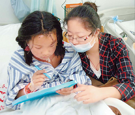 A Tibetan girl practices her writing while she receives treatment in a hospital in Chengdu, capital of Sichuan province. The girl was rescued from a collapsed house in Yushu, epicenter of the 7.1-magnitude earthquake. 