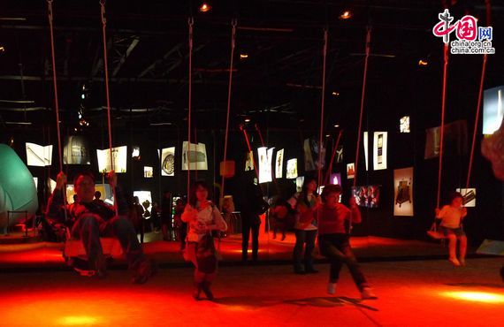 People ride the swings in the Spirit of Innovation Hall in Swedish Pavilion in Shanghai World Expo. [Xu Lin / China.org.cn]