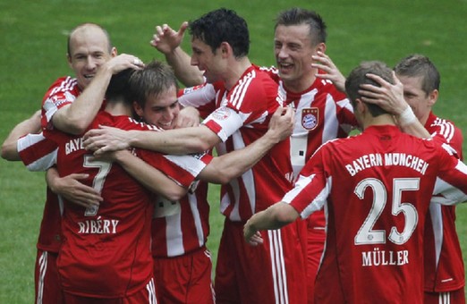 Bayern overpowered Bochum 3-1 thanks to a triple by youngster striker Thomas Mueller to lock the 22nd Bundesliga title on Saturday, while Bremen destroyed Schalkes' champion dreams with a 2-0 victory.