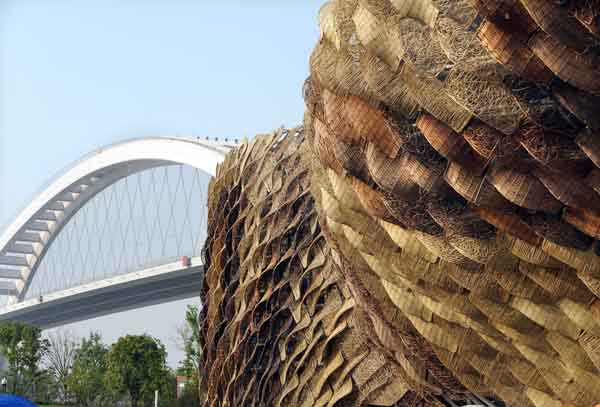 The facade of the Spain Pavilion constructed with hand-weaved wicker basket structure supported by the steel framework inside presents environmental-protective concept and traditional elements in the World Expo in Shanghai, east China, on May 1, 2010. 