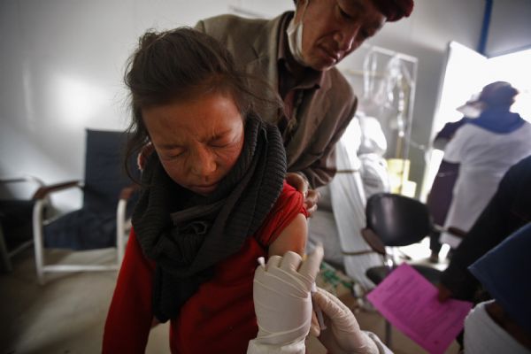 A child is vaccinated in Jiegu Town of northwest China's quake-hit Yushu Prefecture, on May 3, 2010. Over 2,500 children aged 0 to 12 have been vaccinated against measles, parotitis, rubella and hepatitis B so far in Yushu. A total of 6,000 to 7,000 children will be vaccinated. (Xinhua