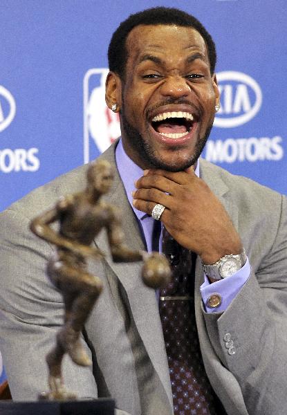 LeBron James of the Cleveland Cavaliers laughs as Cavaliers head coach Mike Brown speaks during a ceremony to present James with the NBA's Most Valuable Player award at the University of Akron in Akron, Ohio May 2, 2010. James becomes the 10th NBA player to win the honor in back-to-back seasons. (Xinhua/Reuters Photo)